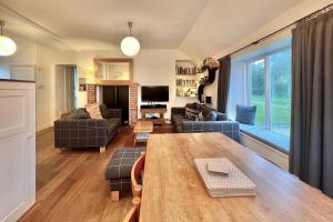 a living room with a table and a couch at Stable Corner, a 4 bedroom rural retreat in Loddiswell