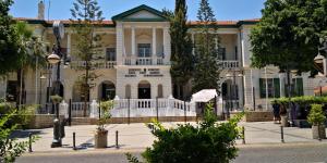 une grande maison avec une clôture blanche devant elle dans l'établissement Chariandry Residence, Limassol City Centre, à Limassol