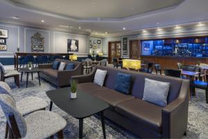 a lobby with couches and tables and a bar at Delta Hotels by Marriott Huntingdon in Huntingdon