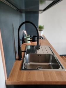 a kitchen counter with a sink in a kitchen at Molo27 CITRA 3979 in Genova
