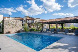 a swimming pool with chairs and a patio at Private Sanctuary 4BR Home with Pool and Gym in San Miguel de Allende