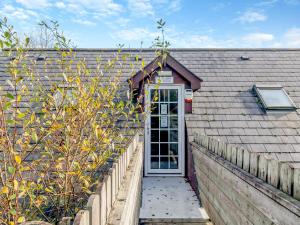 a house with a white door and a fence at Dairy Cottage-uk45593 in Verwick