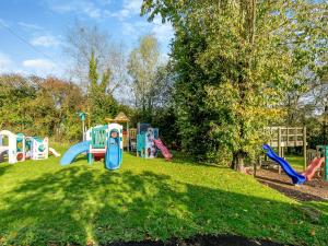 a playground with a bunch of playground equipment in a park at Dairy Cottage-uk45593 in Verwick