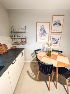 a kitchen with a table and chairs in a room at Closer Place in Tomaszów Mazowiecki