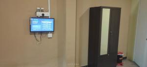a television on a wall next to a medicine cabinet at Hotel Lii View Labis in Labis