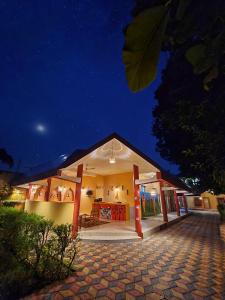 a house with a pavilion at night at Saalwood Safari Lodge in Dhanwār