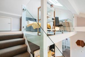 a glass staircase in a house at ARCORE Premium Apartments Bloomsbury in London