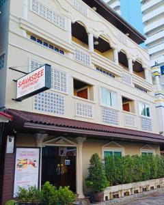 a building with a sign in front of it at Sawasdee Apartment Patong in Patong Beach