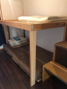 a wooden shelf with a mattress on top of it at Guesthouse MI CASA SU CASA in Zentsuji