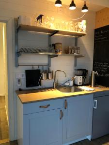 a kitchen with a sink and a counter top at Mariannelund Bed&Beer in Löberöd
