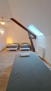 a attic room with two beds and a skylight at Gite étape pour amoureux du vélo Azay centre 12p. in Azay-le-Rideau