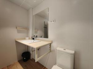 a bathroom with a sink and a mirror and a toilet at Mr luxury Born 1BR Apartment With Balcony in Barcelona