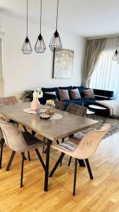 a living room with a wooden table and chairs at New modern accommodation in city in Metković