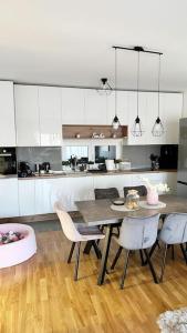 a kitchen with a table and chairs in a room at New modern accommodation in city in Metković
