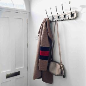 a towel and a purse hanging on a wall at 3 bedroom converted chapel in historic Oundle in Oundle