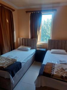 a bedroom with two beds and a window at RP HOTEL- hostel in Yerevan