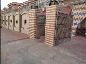 a gate in the side of a building at Bodla Royal Hotel in Multan