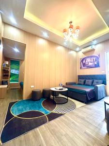 a living room with a bed and a table at Kolor Home/2Brs/Near Hoankiem Lake/Old Quarter in Hanoi
