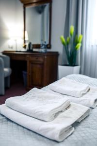 ジェシュフにあるHotel Villa Rivieraのホテルルーム内のベッド2台(白いタオル付)