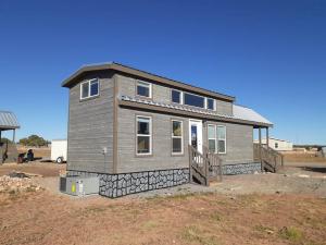 a house that is being constructed in a field at 065 Star Gazing Tiny Home nr Grand Canyon South Rim Sleeps 8 in Valle