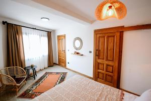 a bedroom with a bed and a door and a window at Kallinos Boutique Hotel in Selcuk