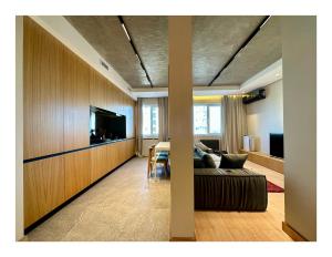 a living room with a couch and a flat screen tv at Deluxe Apartment in Tashkent