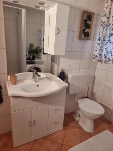 a bathroom with a sink and a toilet and a mirror at Sweet Home in Wermelskirchen +12 photos