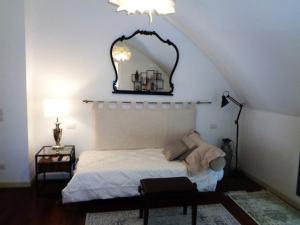 a bedroom with a bed with a mirror on the wall at Ca' Marconi in San Donà di Piave