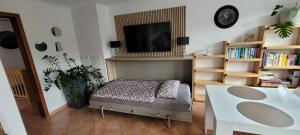 a living room with a table and a tv at Sweet Home in Wermelskirchen