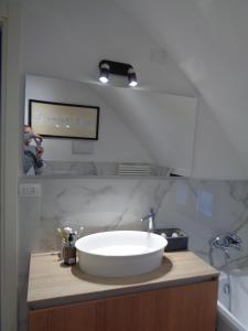 a bathroom with a large white sink on a counter at Ca' Marconi in San Donà di Piave