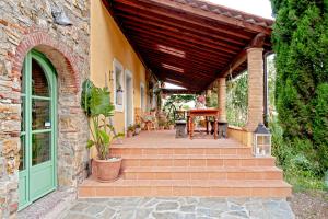 una casa in pietra con portico con tetto in legno di Podere La Gualda Vecchia alloggi di charme immersi nel Giardino Emozionale outdoor SPA a Monteverdi Marittimo