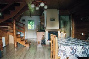 a room with a bed and stairs in a house at Domki Bieszczadnik in Hoczew