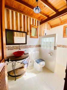 a bathroom with a toilet and a wooden ceiling at At Home Chiang Dao, Pooch Lovers in Ban Tham