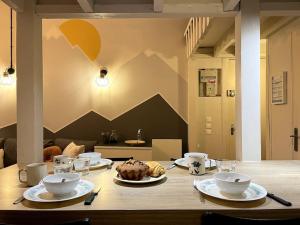 a table with plates of food on top of it at Montagn'Art Studio. 4pers 30m2. Coeur village. in Cauterets