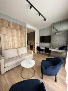a living room with a couch and a table at BW Lux Apartments in Sajmište