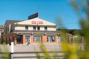 a building with a sign on the top of it at Hostal Venta de Valcorba in Soria