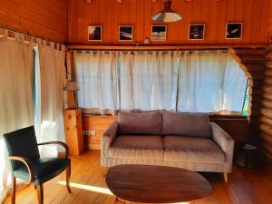 a living room with a couch and a chair at CHALET RONDIN JURA in Aromas