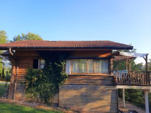 a log cabin with a porch and a deck at CHALET RONDIN JURA in Aromas +9 photos