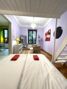 a large white bed in a room with purple walls at Old Cracow Style in Krakow