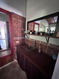 a bathroom with a sink and a large mirror at EL PARAISO G - FINCA HOTEL LGBT - ADULTS ONLY in San Vicente