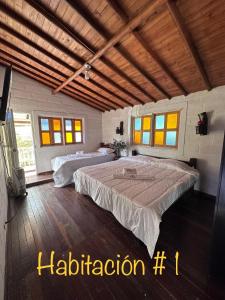 a bedroom with two beds in a room with windows at EL PARAISO G - FINCA HOTEL LGBT - ADULTS ONLY in San Vicente