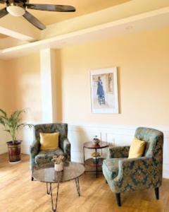 - un salon avec deux chaises et une table dans l'établissement Shalom Farmhouse Imphal, à Imphal