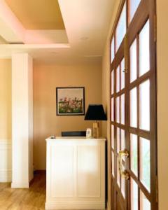 un couloir avec une porte et une table avec une lampe dans l'établissement Shalom Farmhouse Imphal, à Imphal