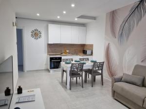 a kitchen and living room with a table and chairs at La Casa di Mimi in Monopoli