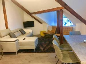 a living room with a couch and a table at The Penthouse in Windermere in Windermere