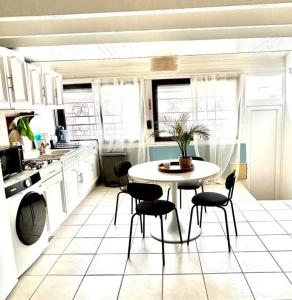 a kitchen with a table and chairs in it at Le Cabanon à Pépé, aux Goudes in Marseille