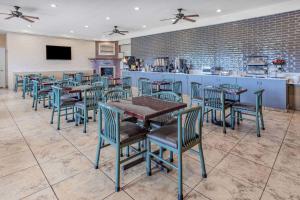 a restaurant with tables and chairs and a bar at Ramada by Wyndham West Atlantic City in West Atlantic City