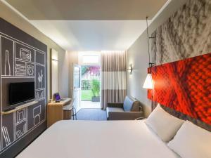 a hotel room with a bed and a living room at ibis Paris Gare de Lyon Ledru Rollin in Paris