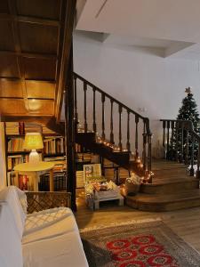 a living room with a staircase with a christmas tree at Casa Boixareu in La Pobla de Segur
