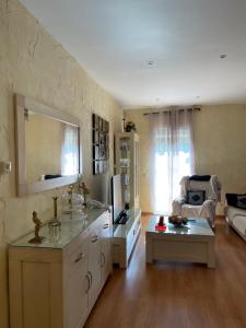 a kitchen with a sink and a living room at Casa La Pradera Cañete in Cañete